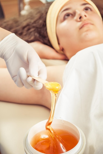 sugaring armpit wax in a professional cosmetologist