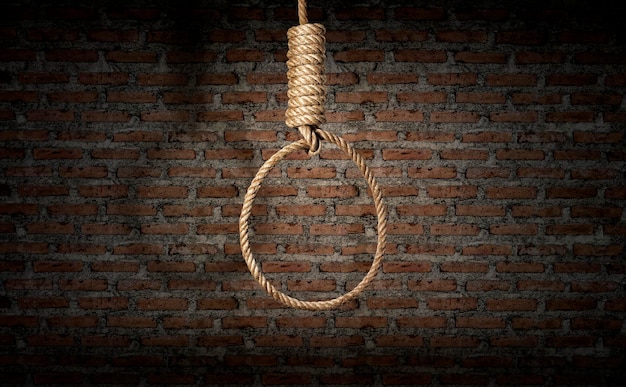 Suicide concept noose with shadow on dark wall background