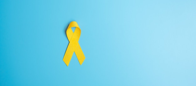 Prevenzione del suicidio, sarcoma, ossa, vescica, mese di sensibilizzazione sul cancro infantile, nastro giallo per sostenere le persone che vivono e le malattie. assistenza sanitaria per bambini e concetto di giornata mondiale del cancro