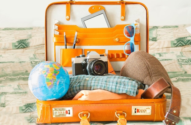 旅行用のアイテムがいっぱい入ったスーツケース。幻想、希望、喜び、そして新しい目的地。