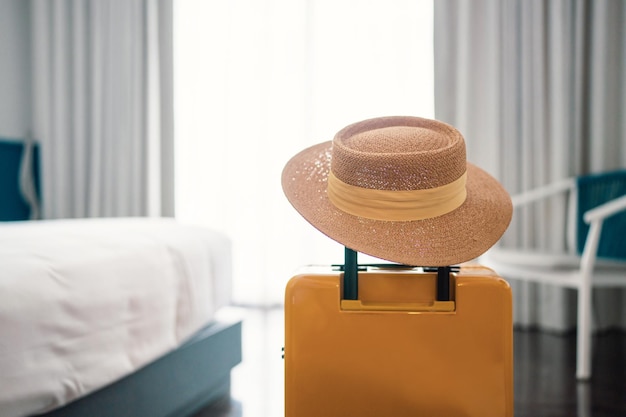 Suitcase or luggage bag with hat in a modern hotel room