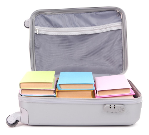 Suitcase with books isolated on white