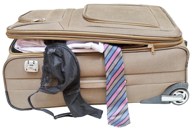 Suitcase with fell out male tie and female bra