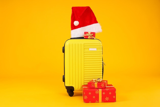 a suitcase with a new year's hat and gifts