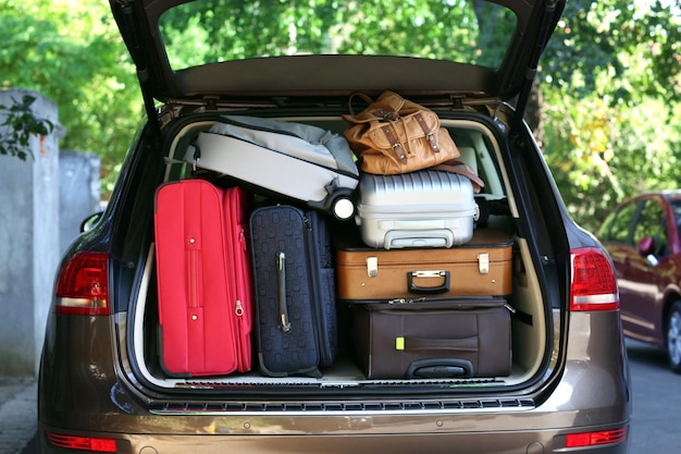 Suitcases and bags in trunk of car ready to depart for holidays