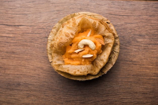 Suji or Sooji Halwa Puri or Shira Poori breakfast, served in a plate and bowl. selective focus