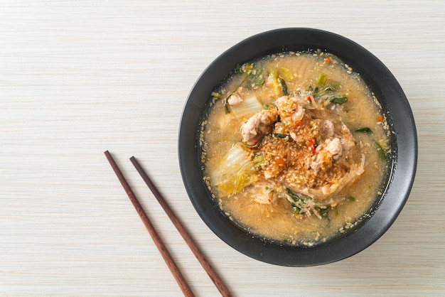 Sukiyaki soup with pork in thai style or boiled vermicelli with\
pork and vegetables in sukiyaki soup - asian food style