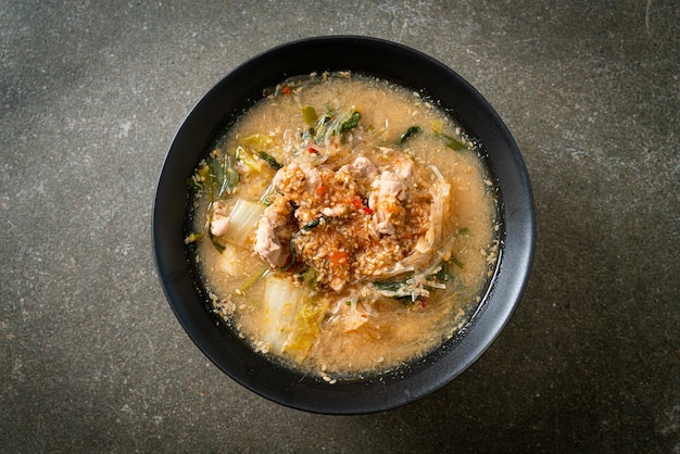 Sukiyaki soup with pork in thai style or boiled vermicelli with\
pork and vegetables in sukiyaki soup - asian food style