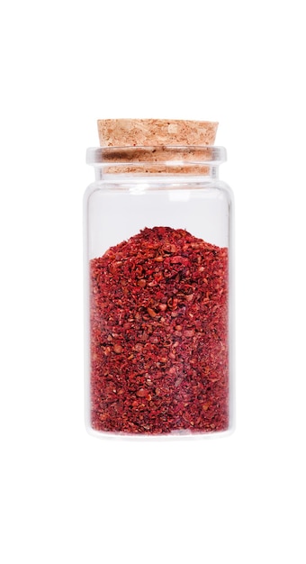 Sumac in a glass bottle with cork stopper isolated on white