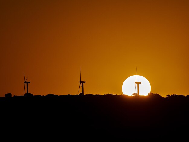 Sumer sunset with the sun disk behind the wind generators montealegre del castillo spain