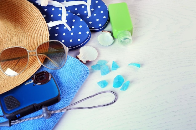 Summer accessories on wooden table close up