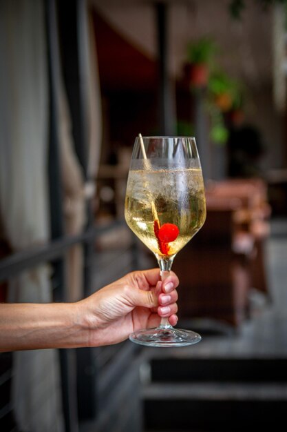 Summer alcoholic cocktail Aperol lillet spritz with cherry a beach refreshing cocktail at the bar