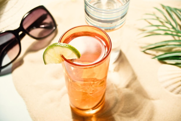 Summer alcoholic cocktails in colorful glasses on beach with white sand Summer sea ocean vacation and travel concept