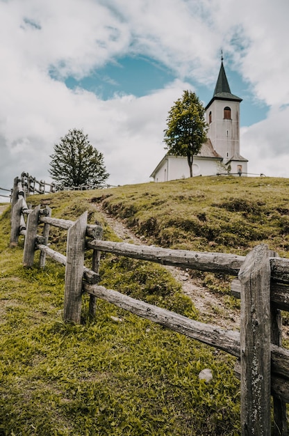 Summer alpine countryside landscape with high mountains and church Logar valley Logarska Dolina from the panoramic road Solcava Slovenia