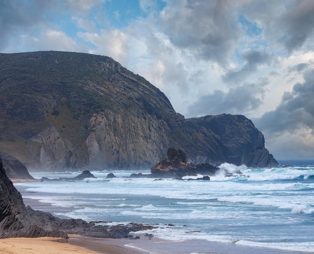 Summer Atlantic rocky coast and ocean storm on Castelejo beach Algarve Portugal