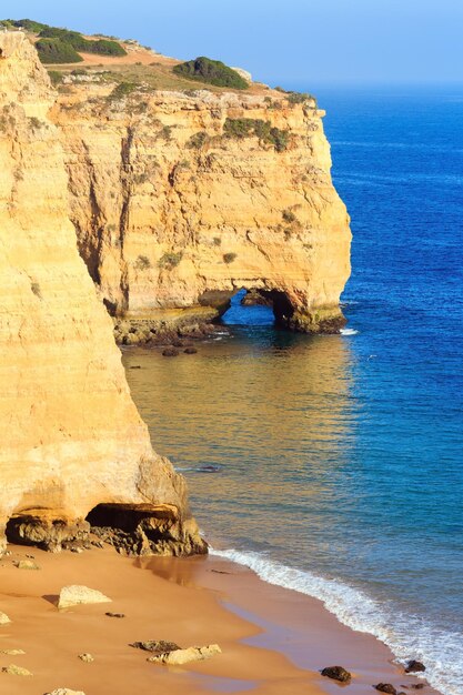 Summer Atlantic rocky coast view with sandy beach Praia da Afurada (Lagoa, Algarve, Portugal).