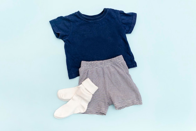 Summer babies blue clothes and accessories with t shirtshortssocks Modern fashion kids outfitSet of children's clothing for spring or summer Flat lay top viewoverheadmockup