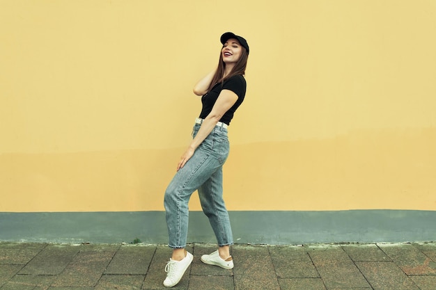 Summer background. Beautiful young girl on a colored background. City location