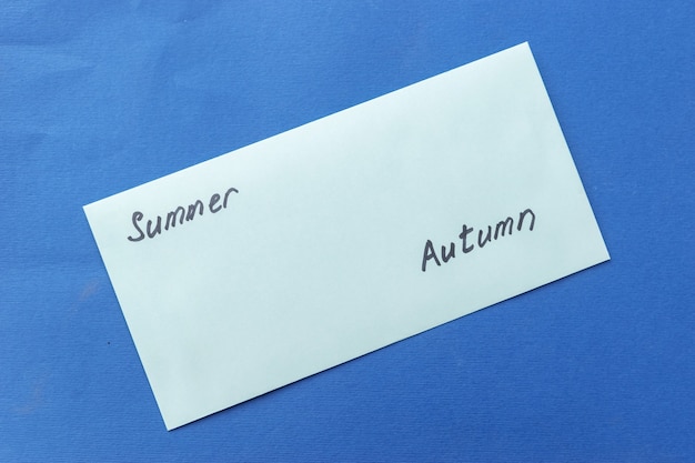 Summer background of shell, envelope with the inscription summer autumn on blue background