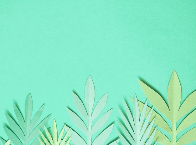 Summer background with colorful paper tropical leaves.