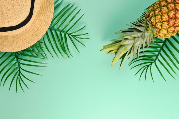 Summer background with hat and pineapple