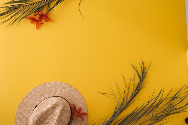 Summer background with straw hat and bag and palm leaves