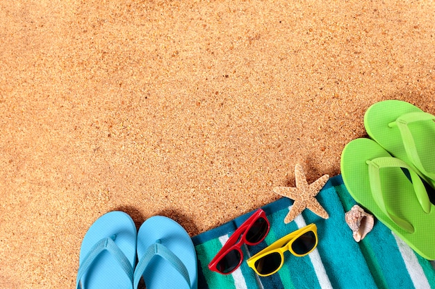 Summer beach background border, flip flops, sand copy space