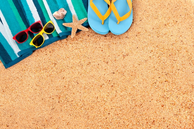 Summer beach background border, flip flops, sand copy space