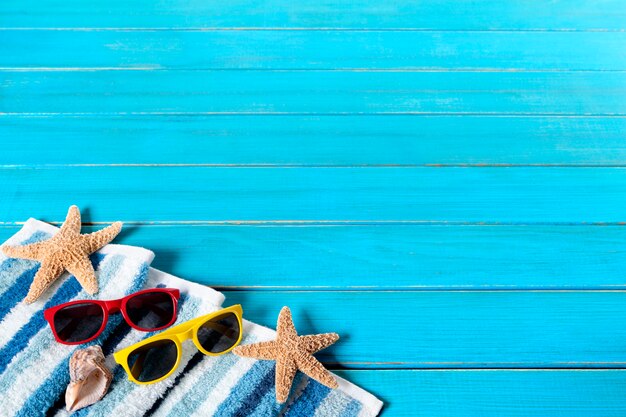 Summer beach background border, sunglasses, starfish, wood decking, copy space