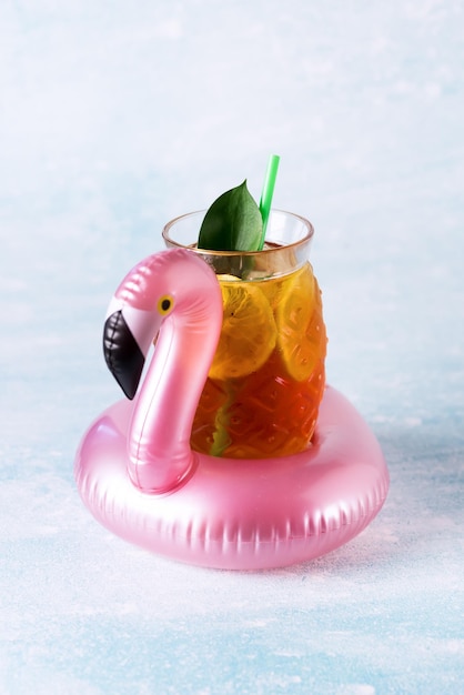 Summer Beach composition Inflatable Mini flamingo with Cold Drink on Pastel blue background