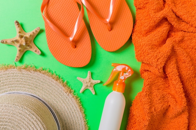 Summer beach flat lay accessories. Sunscreen bottle cream