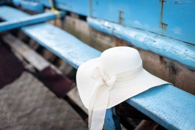 Summer beach hat on old boat no people