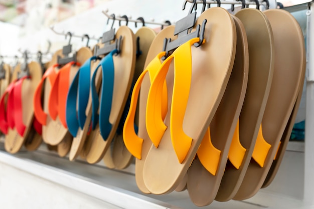 Summer beach Slippers in a row, hanging on the exhibition counter shop window