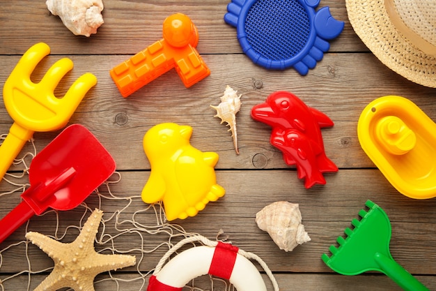 Summer beach toys on grey wooden background. Top view