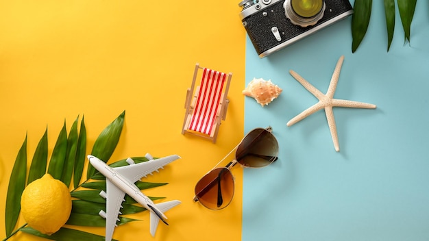 Summer beach vibes background compositions Travel accessories on yellow and blue background