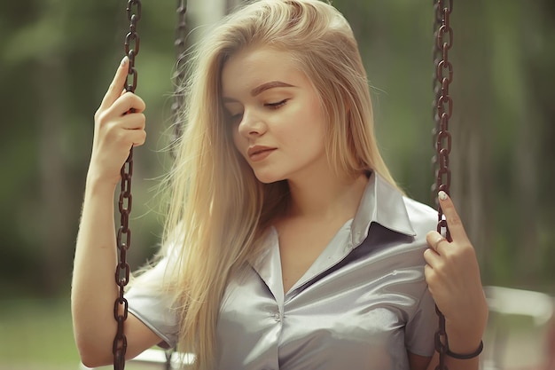 Summer beautiful young blonde in the park