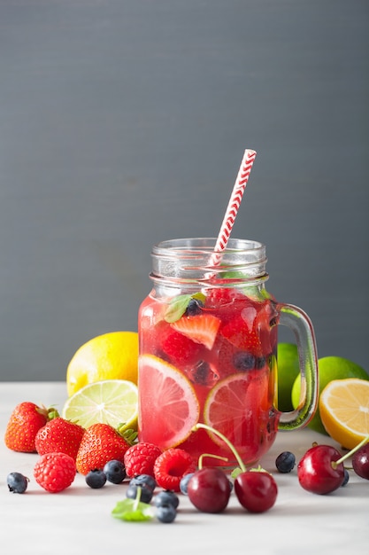 Summer berry lemonade with lime and mint in mason jar