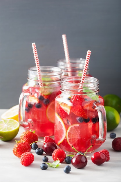 Summer berry lemonade with lime and mint in mason jar