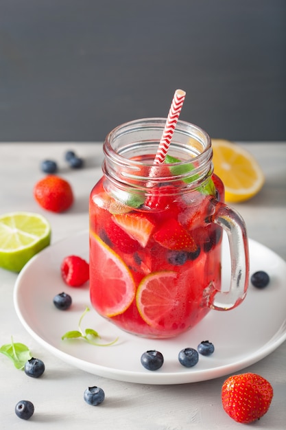 Summer berry lemonade with lime and mint in mason jar