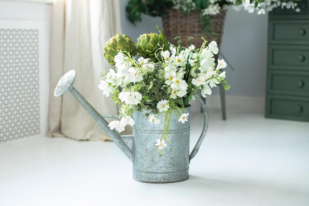 Summer bouquet of flowers in watering can