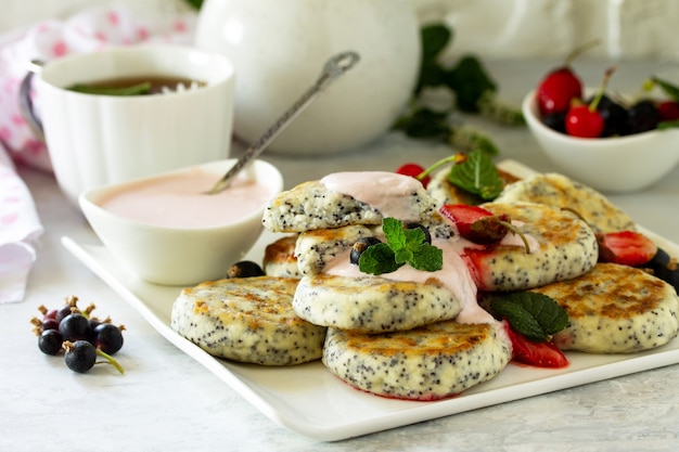 Summer breakfast background Homemade cottage cheese pancakes with poppy seeds