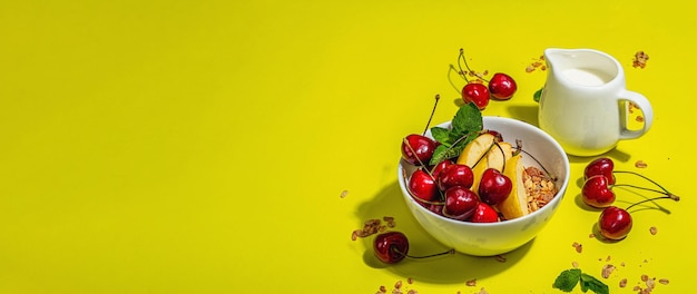 Summer breakfast concept healthy morning food ripe cherries apples milk and granola