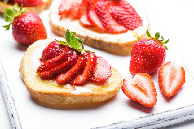 Summer breakfast - toasts with butter and strawberry