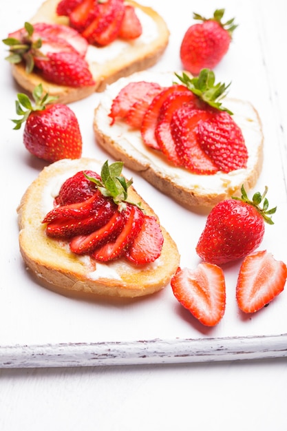 Summer breakfast - toasts with butter and strawberry