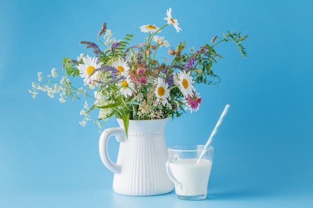 Summer breakfast with milk and wildflowers