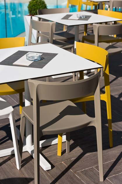 Summer cafe with plastic furniture near swimming pool