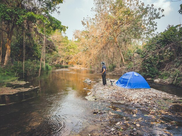 Photo summer camping tent near the stream