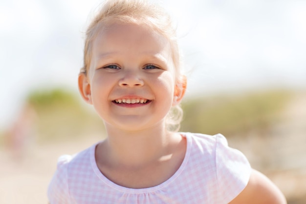 summer, childhood, happiness and people concept - happy beautiful little girl portrait outdoors