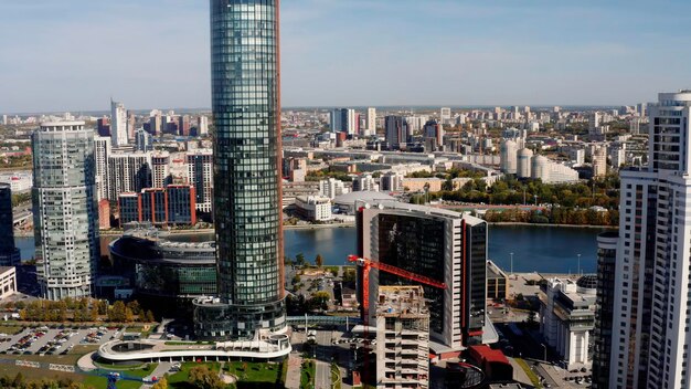 Summer cityscape and a wide river flowing along the buildings stock footage construction site and