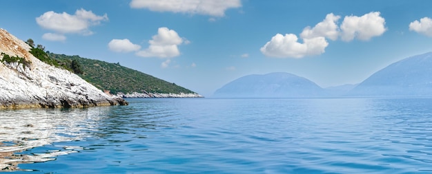 Summer coast view from motorboat Kefalonia not far from Agia Effimia Greece and Ithaka island on right Panorama